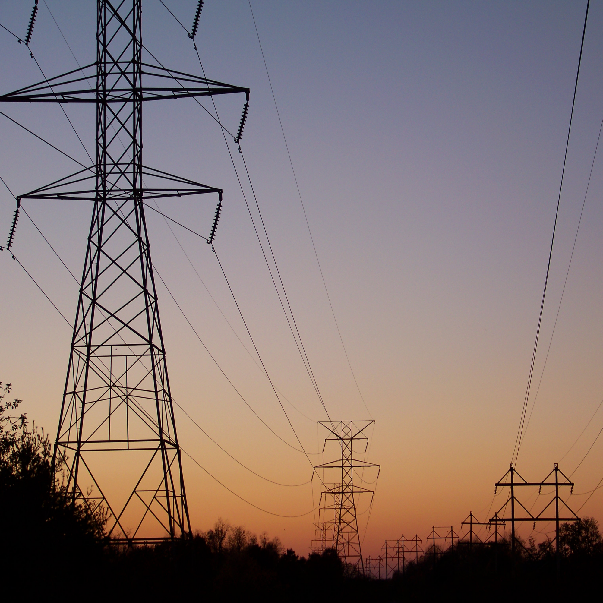 transmission lines with sunset in background